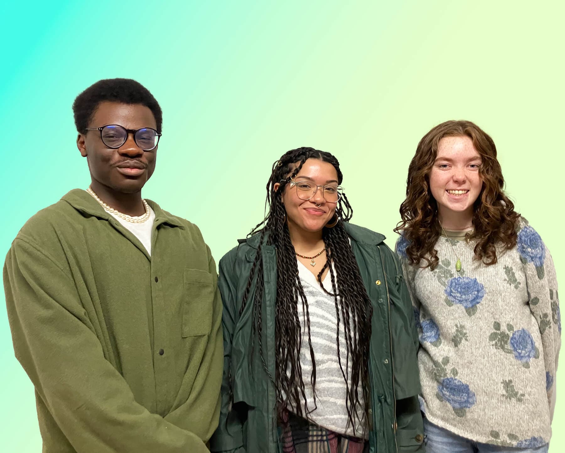 Three young adults pose together smiling against a turquoise to pale green gradient background.