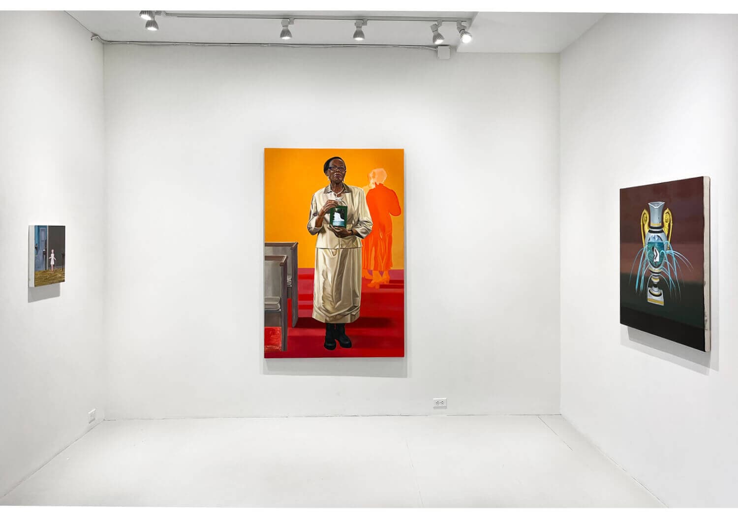 Shantel Miller's grandmother holds the image of a waterfall, standing in front of an orange wall.